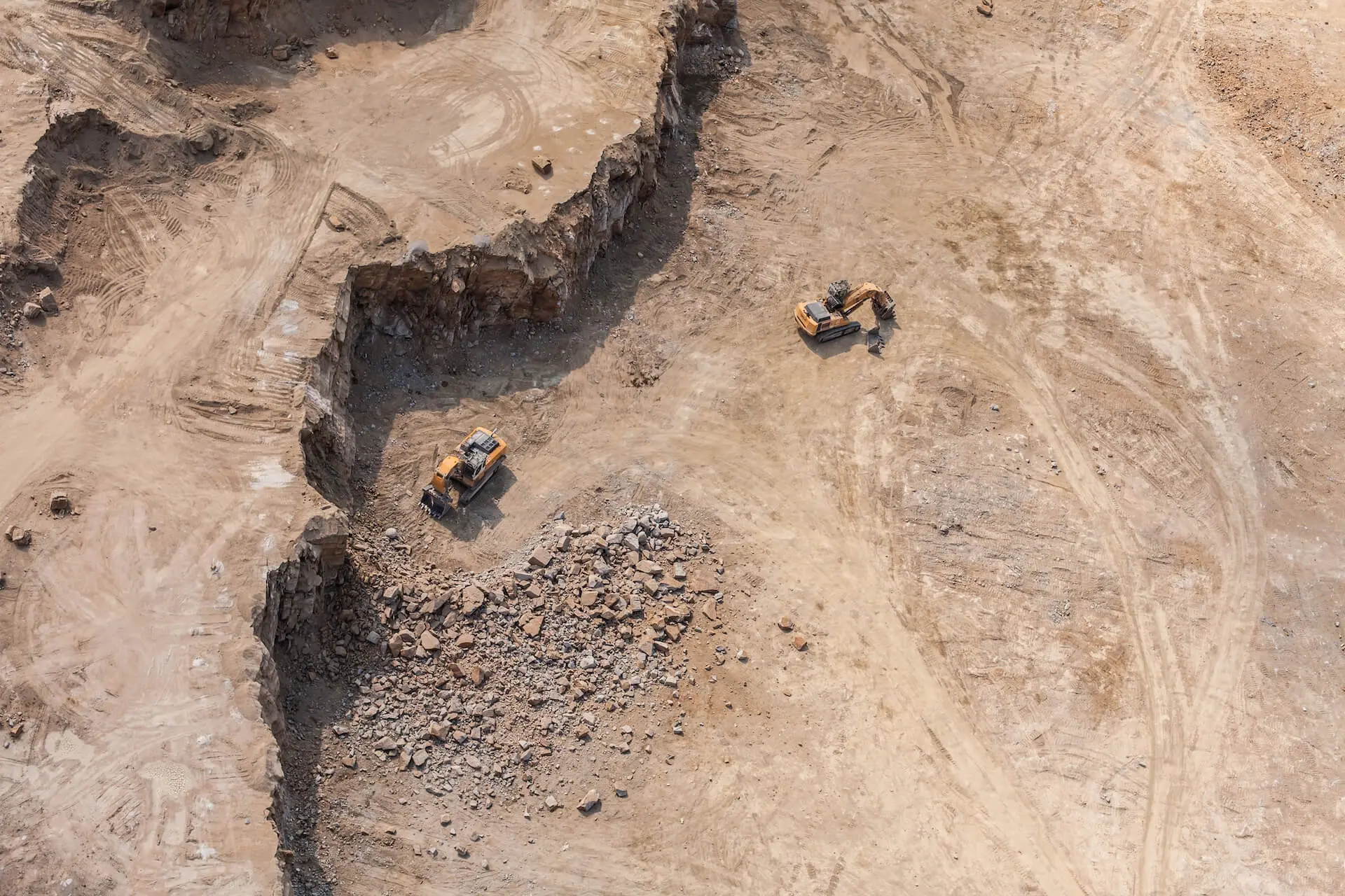 Aerial view of earthmoving equipment operating in an open-pit mine.
