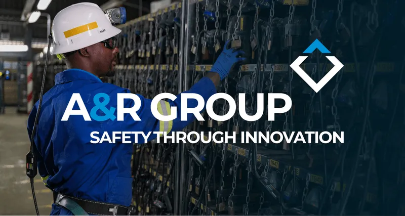 A worker in blue protective gear and a white helmet operates equipment in an industrial setting. The text "A&R Group Safety Through Innovation" and a stylized logo are overlaid on the image.